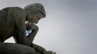 A 'Thinker' drowns in plastic garbage as UN treaty talks open
