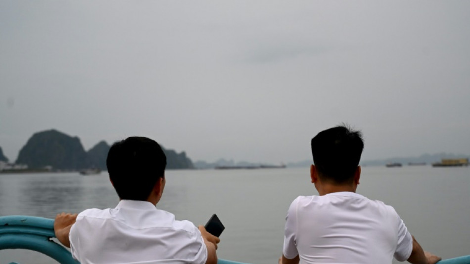 Anxious relatives await news from Vietnam wreck rescue