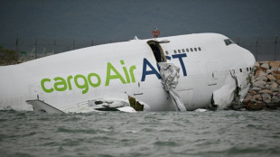 Cargo plane skids off Hong Kong runway, kills two 